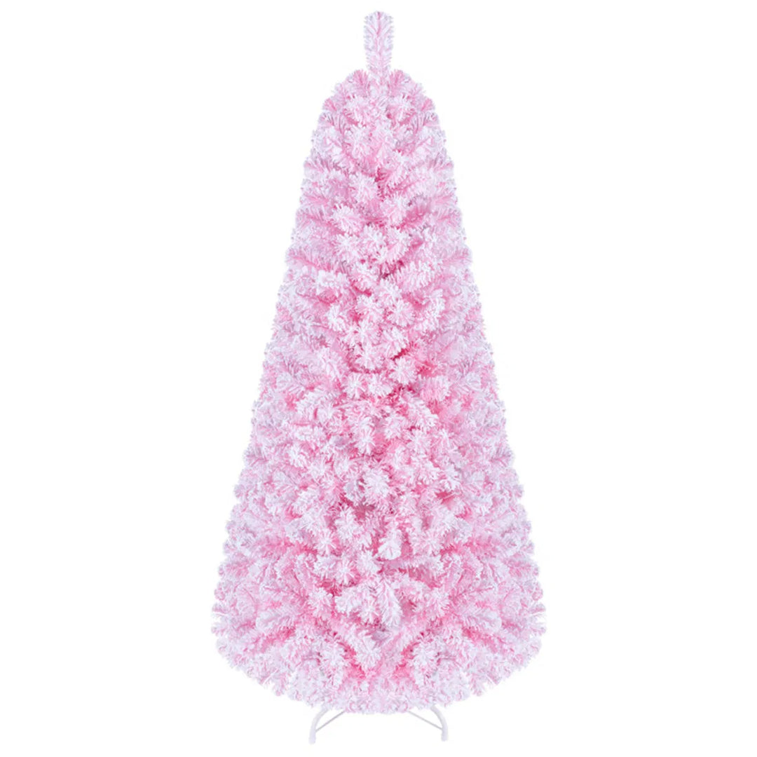 Liten rosa flockad julgran med ljus