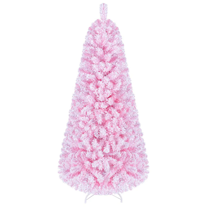 Liten rosa flockad julgran med ljus