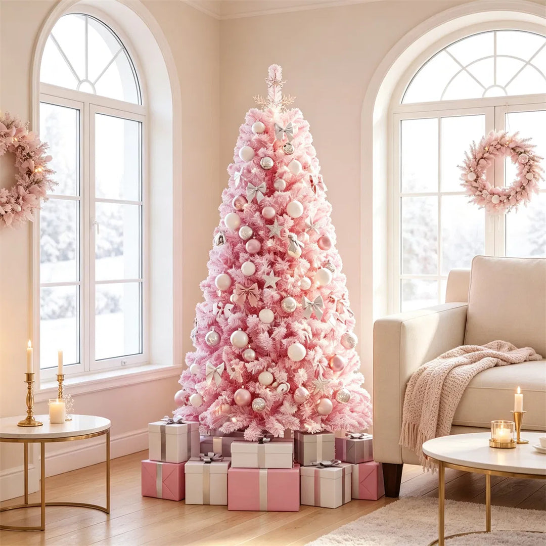 Liten rosa flockad julgran med ljus
