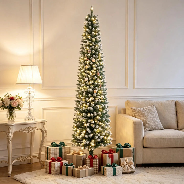 Smal frosttoppad julgran med ljus