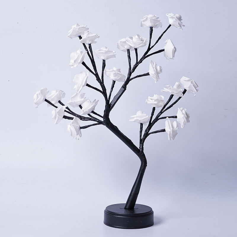 Rosenträdslampa med rosa rosor som lyser