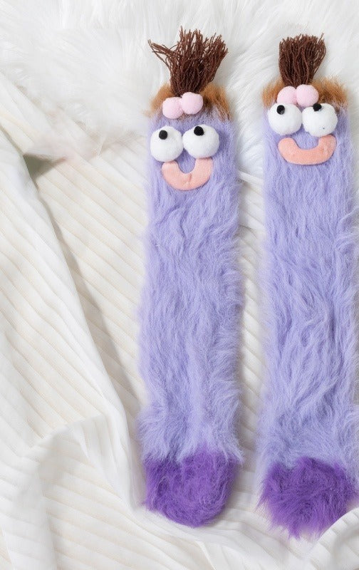 Värmekällan Fluffiga monstersockor med roliga ansikten