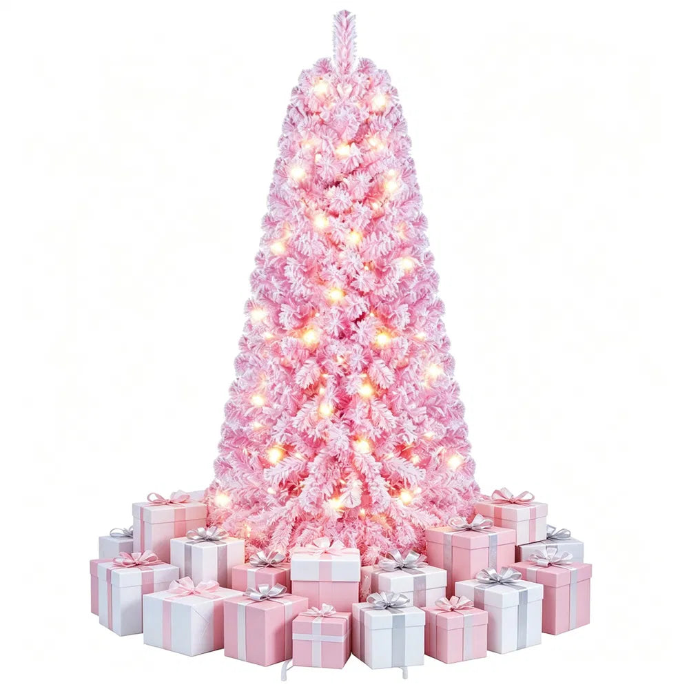 Liten rosa flockad julgran med ljus