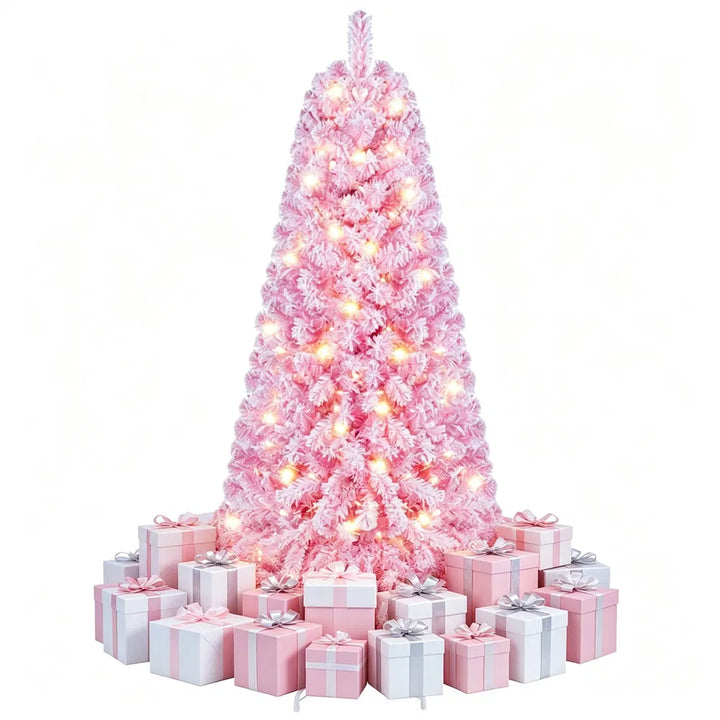 Liten rosa flockad julgran med ljus