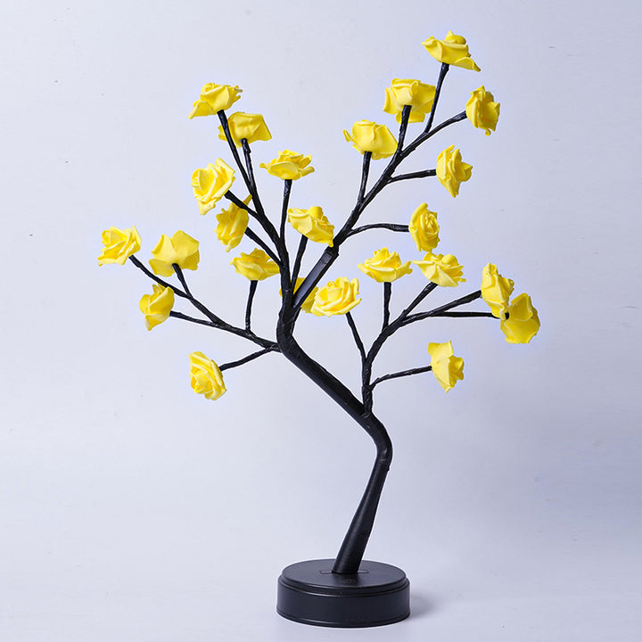 Rosenträdslampa med rosa rosor som lyser